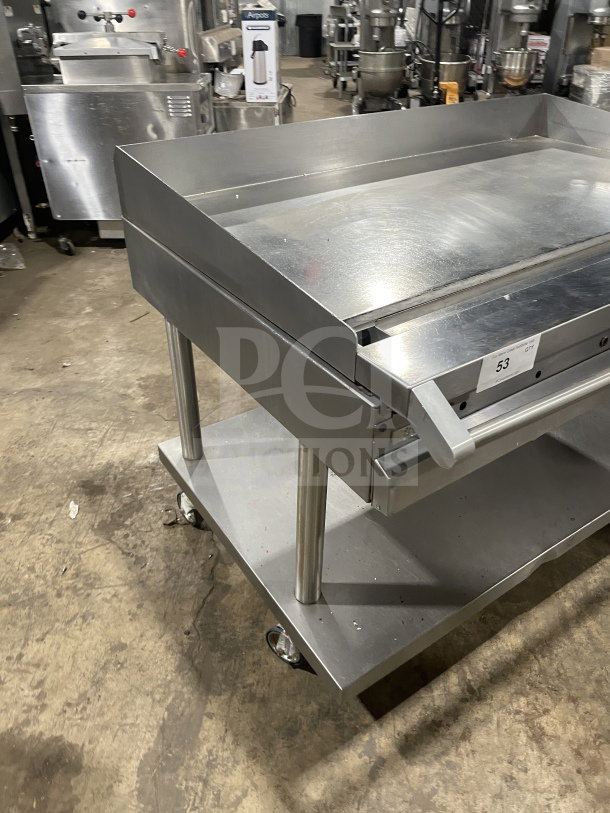 Vulcan 48" stainless steel flat griddle with back and side splashes, model 48RRGCKR1, on casters, includes storage space, natural gas powered.