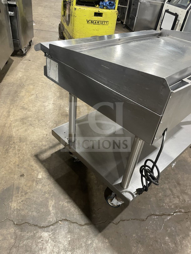 Vulcan 48" natural gas flat griddle, model 48RRGCKR1, stainless steel with back and side splashes, on equipment stand with storage.