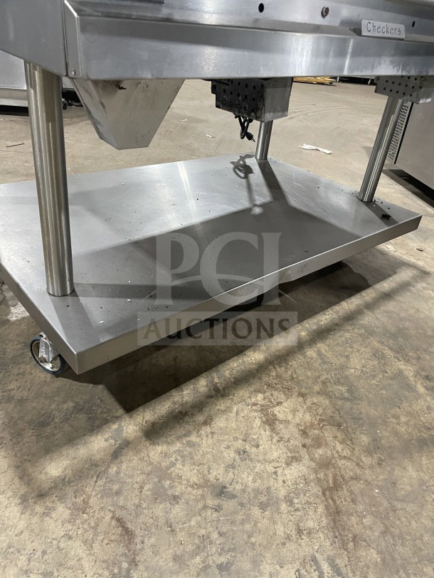 Vulcan 48" stainless steel griddle, model 48RRGCKR1, with back and side splashes, equipment stand, and storage, on casters.