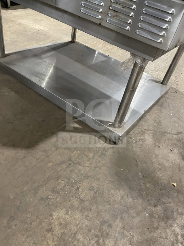 US Range stainless steel convection oven on stand, Model SUMG100. Features view-through doors, wired rack, storage space.