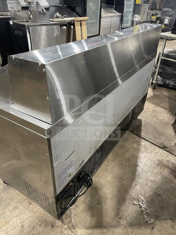 Commercial stainless steel 3-door bain marie sandwich prep refrigerator, Model SC72BMI, on casters, poly coated rack.