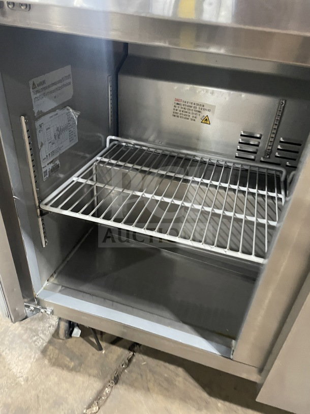 Commercial stainless steel 3-door Bain Marie prep refrigerator, Model SC72BMI, with poly-coated wired rack, on casters.