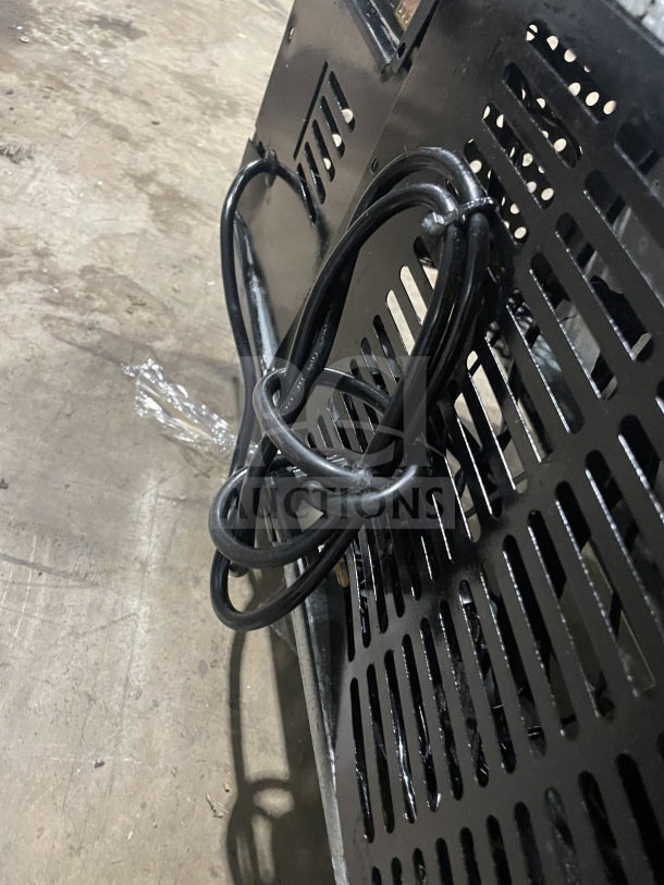 Commercial stainless steel prep refrigerator back panel, power cord visible. Model SC72BMI, serial 9142400052, on casters.