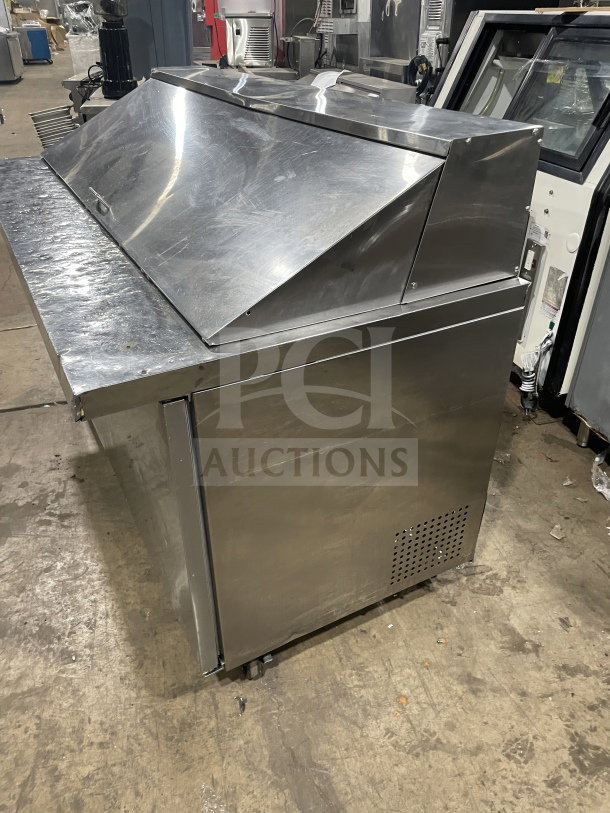 Commercial stainless steel 3-door prep refrigerator, model SC72BMI, with poly coated rack and casters, visible wear.
