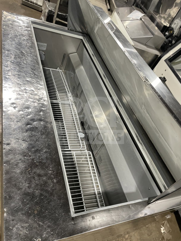 Commercial stainless steel 3-door bain marie prep refrigerator, Model SC72BMI, with poly-coated wire rack, on casters.