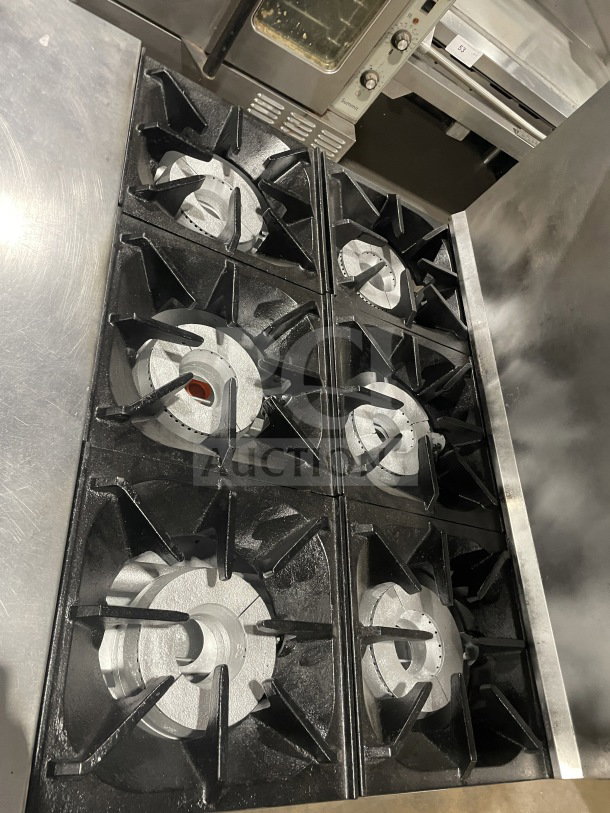 Bakers Pride 36BP6BS30N 6-burner stainless steel range with oven, backsplash, and salamander shelf. Commercial-grade, natural gas.