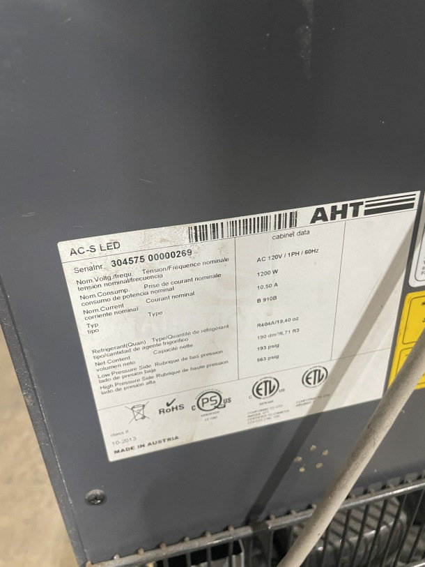 AHT AC-S LED refrigerated open grab-n-go case, model 2013, serial 30457500000269, on casters with pull-down night shade.