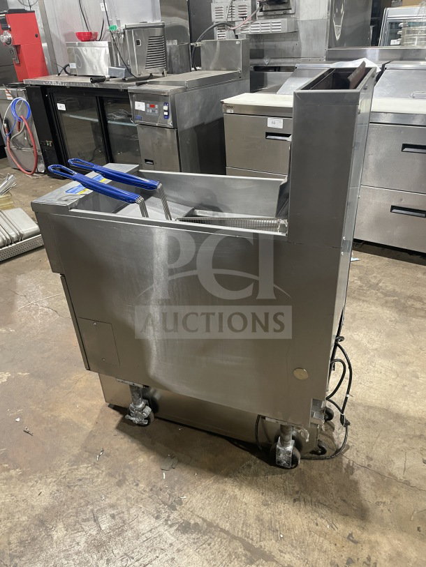 Pitco SFSG14 JS commercial 40 lb. stainless steel deep fryer on casters with filtration system, backsplash, and basket hanger.