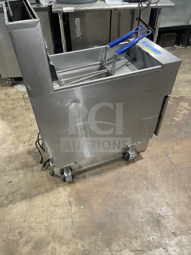 Pitco SFSG14 JS 40 lb. stainless steel gas fryer with backsplash, basket hanger, filtration system, on casters, SN: G12MC060863.