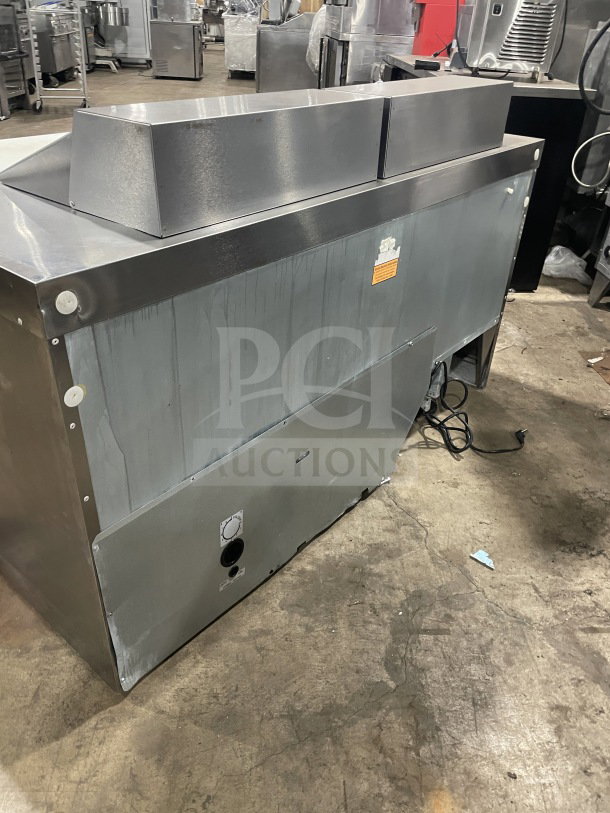 Delfield Manitowoc stainless steel refrigerated prep table, model UCD4464N-12-DD5, with cutting board; good condition.