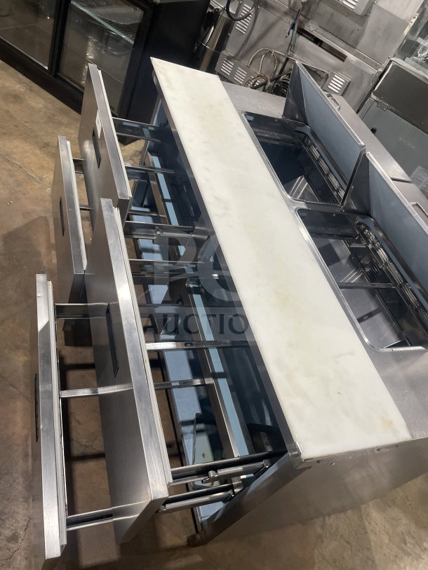 Delfield Manitowoc stainless steel 4-drawer refrigerated sandwich prep table, model UCD4464N 12 DD5, with cutting board.