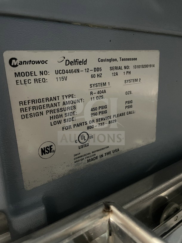 Delfield Manitowoc stainless steel 4-drawer refrigerated prep table, model UCD4464N-12-DD5. Features a cutting board, 115V.