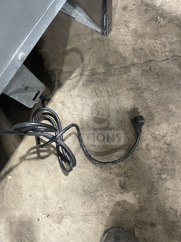 Power cord of Delfield Manitowoc stainless steel refrigerated sandwich prep table, model UCD4464N-12-DD5. 