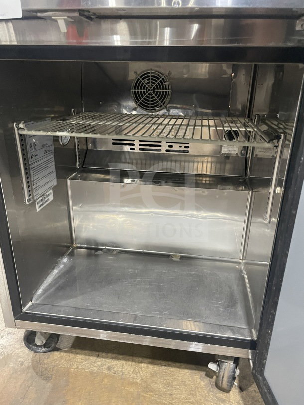 Turbo Air Eur-28-N6 stainless steel undercounter refrigerator, poly coated wire rack, on casters, model and serial tags visible.