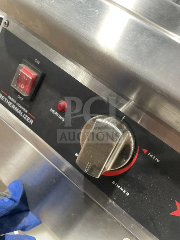 Omcan Model 41882 stainless steel pasta cooker control panel, featuring power switch and heating dial.