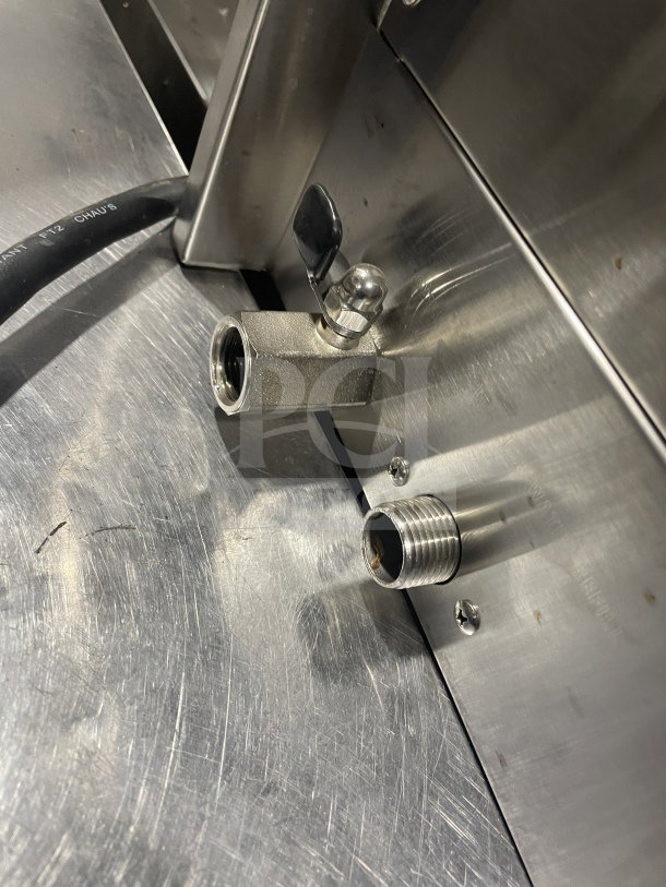 Omcan model 41882 commercial stainless steel pasta cooker, showing water inlet valve and part of the stainless steel surface. 