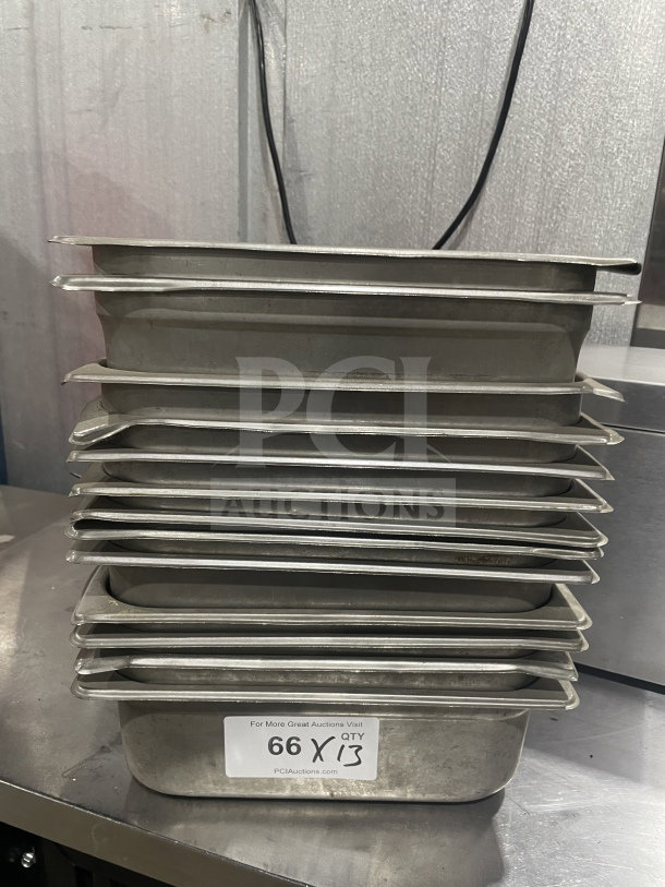 Stack of commercial stainless steel food storage trays, used for sauces or salads. Includes quantity label "66 X QTY 13".