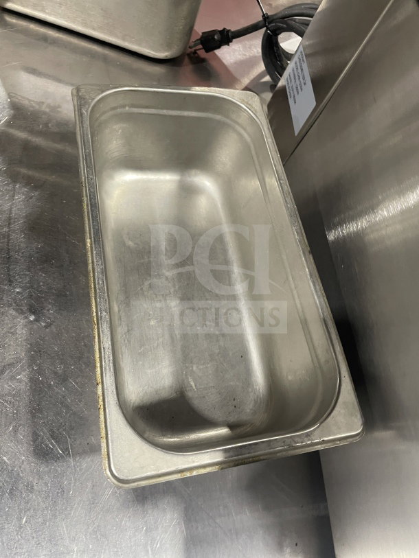 Commercial stainless steel food storage container, rectangular, good condition, durable, measures approximately 12x.