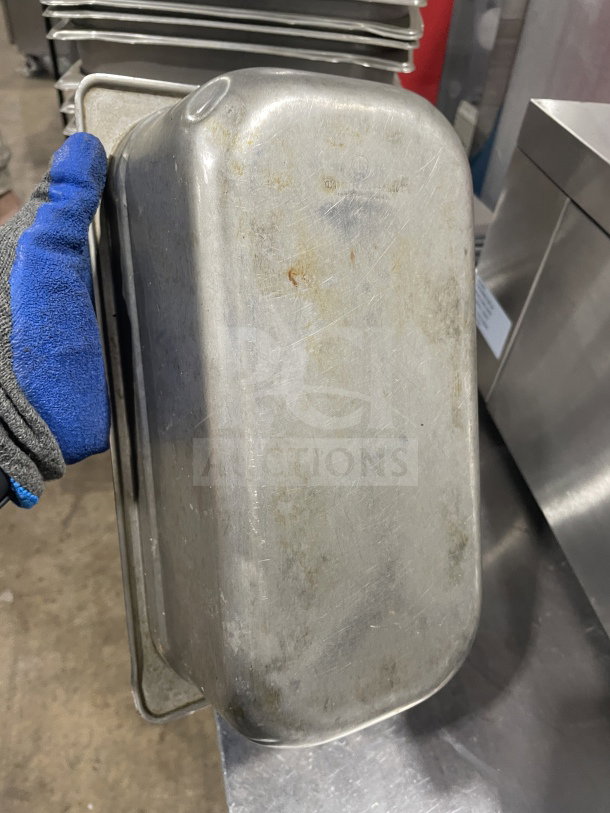 Commercial stainless steel food storage container with signs of use, scratches, and slight discoloration. Measures 12X.