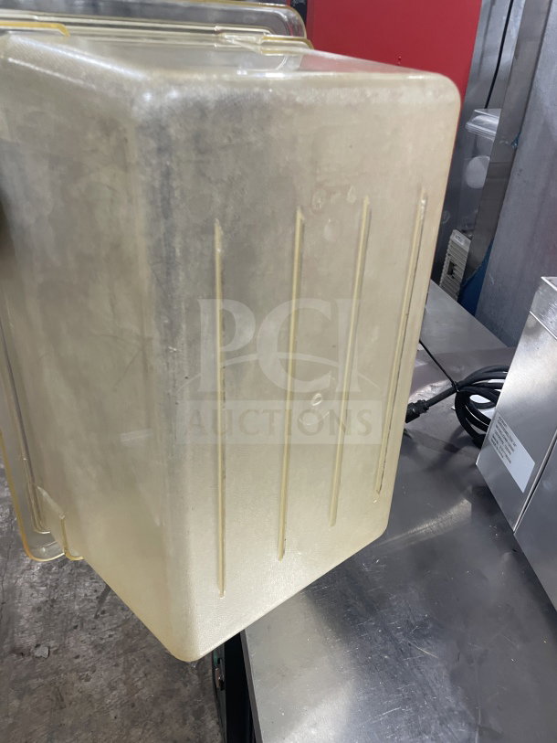 Commercial polycarbonate jumbo food storage container, transparent, with ribbed sides; large capacity, slight wear visible.