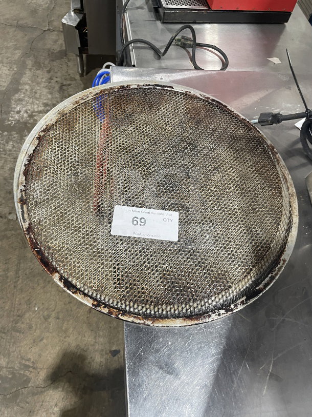 Commercial stainless steel pizza holder, heavy-duty, showing signs of use with mesh surface, auction label "#69".