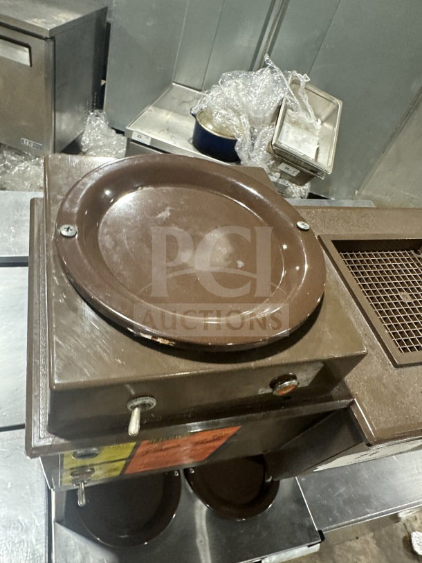 Cecilware commercial stainless steel base coffee machine, countertop model, with used brown surface, visible dials, and labels.