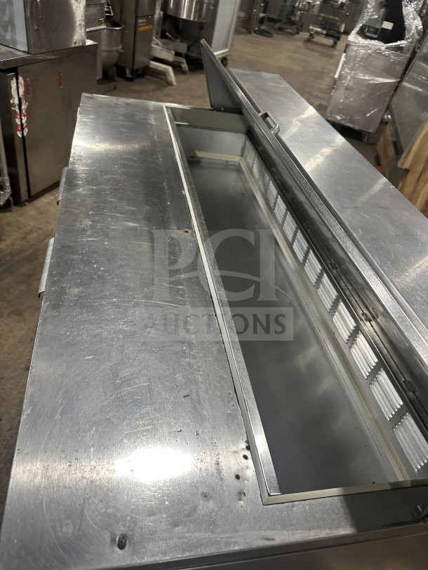 Beverage Air stainless steel 60" refrigerated sandwich prep table, two doors, poly coated rack, on casters, 115V, used condition.