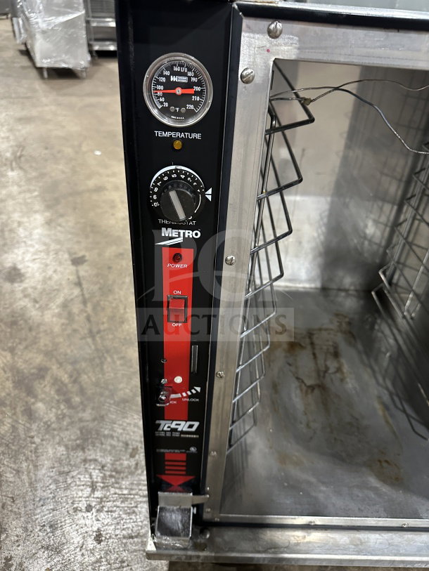 Metro Flavor Hold TC90B food warming cabinet, black and silver, temperature gauge, power switch, and interior rack visible. 120V.