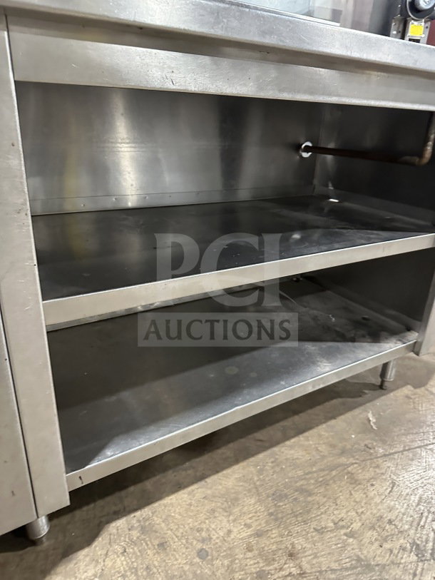 Delfield stainless steel undercounter refrigerator chef base with integrated open storage shelves and chrome wire rack, used.