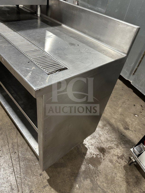 Delfield stainless steel undercounter refrigerator chef base, features integrated open storage shelves and chrome wire rack.