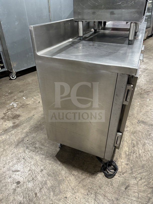 Delfield stainless steel undercounter refrigerator chef base with integrated shelves and chrome-plated wire rack. Signs of wear.