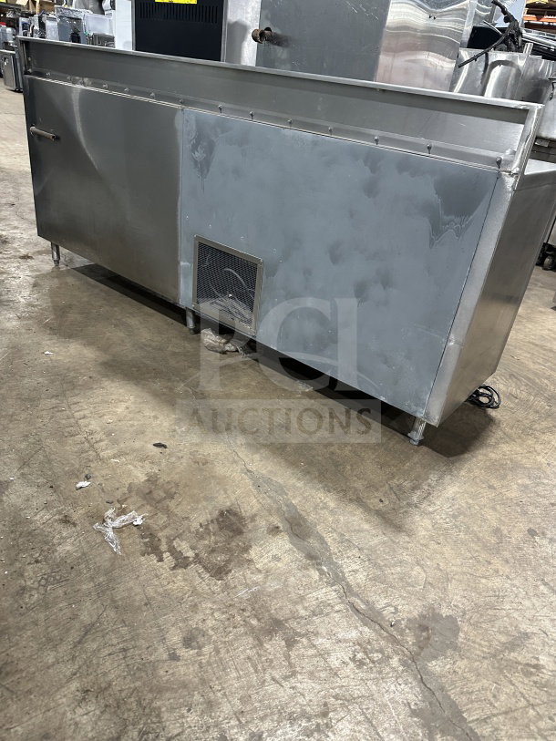 Delfield stainless steel undercounter refrigerator chef base with integrated open storage shelves, chrome wire rack, used condition.