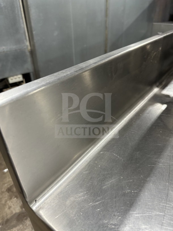 Delfield stainless steel undercounter refrigerator chef base with open storage and chrome wire rack. Clean condition.