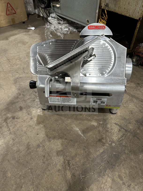Tor-Rey R-300A electric deli meat slicer, stainless steel, countertop model, on legs, visible brand nameplate, used condition.