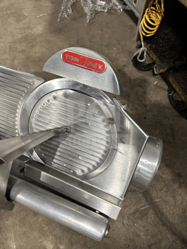 Tor-Rey R-300A commercial deli slicer, electric, countertop, on legs. Features visible red logo. Used condition.