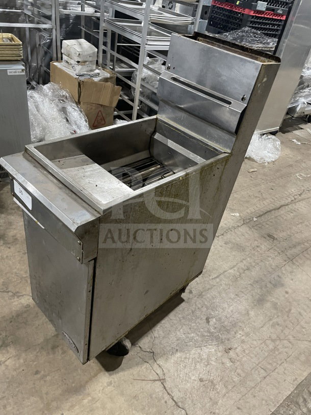 Commercial stainless steel gas-powered fryer with backsplash, showing some wear. Ideal for high-volume frying.
