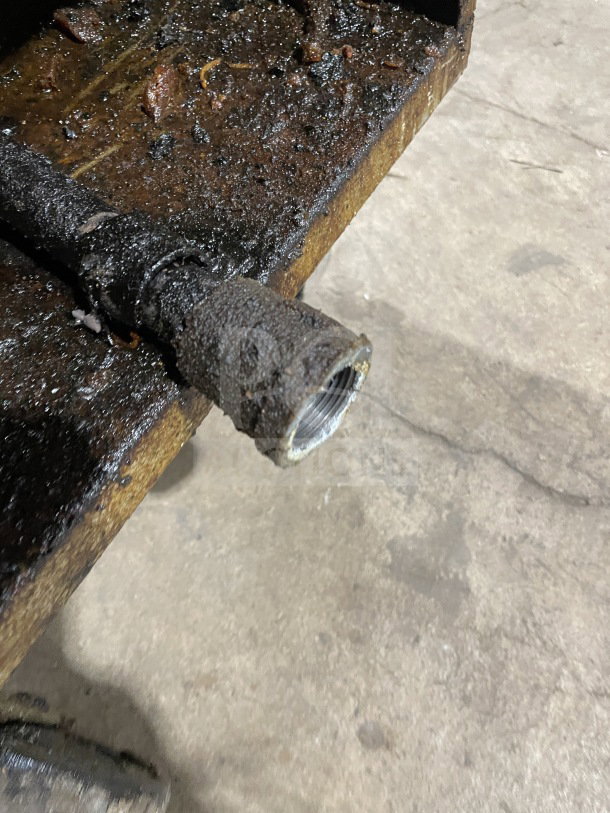 Commercial stainless steel gas-powered fat fryer with backsplash, visible wear, rust, and residue buildup. Suitable for parts or refurbishing.