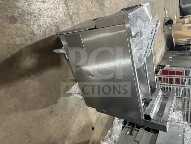 Pitco SE14T commercial stainless steel split tank fryer with backsplash, basket hanger, and new fry basket. Electric powered, on legs.