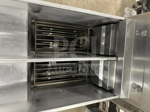 Pitco SE14T stainless steel split tank electric fryer with backsplash, basket hanger, new fry basket, and individual controls.
