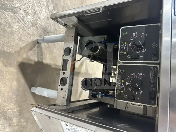 Pitco SE14T stainless steel electric split tank fryer with backsplash, basket hanger, new fry basket, and individual controls.
