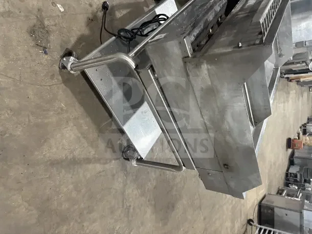 Commercial stainless steel electric countertop griddle with split divider, back and side splashes, on mobile stand with casters.