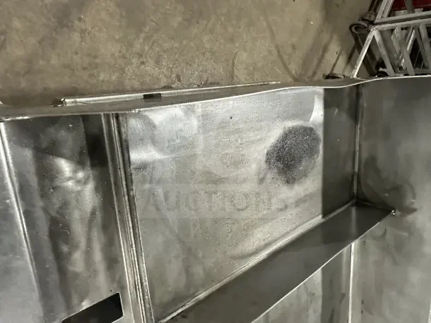 Commercial stainless steel countertop griddle with split divider, back and side splashes, on mobile stand with casters.