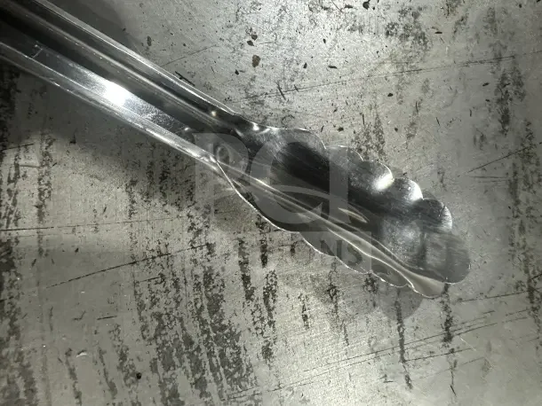 Brand new Cambro Lugano Series 12" black stainless steel food tongs, model 12TGS110, perfect for commercial use.