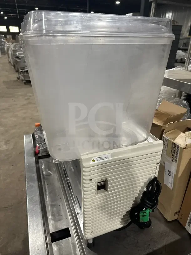 Crathco commercial beverage machine, model D35-4, with three hoppers. Serial number TT539395. 115V, on legs, good condition.
