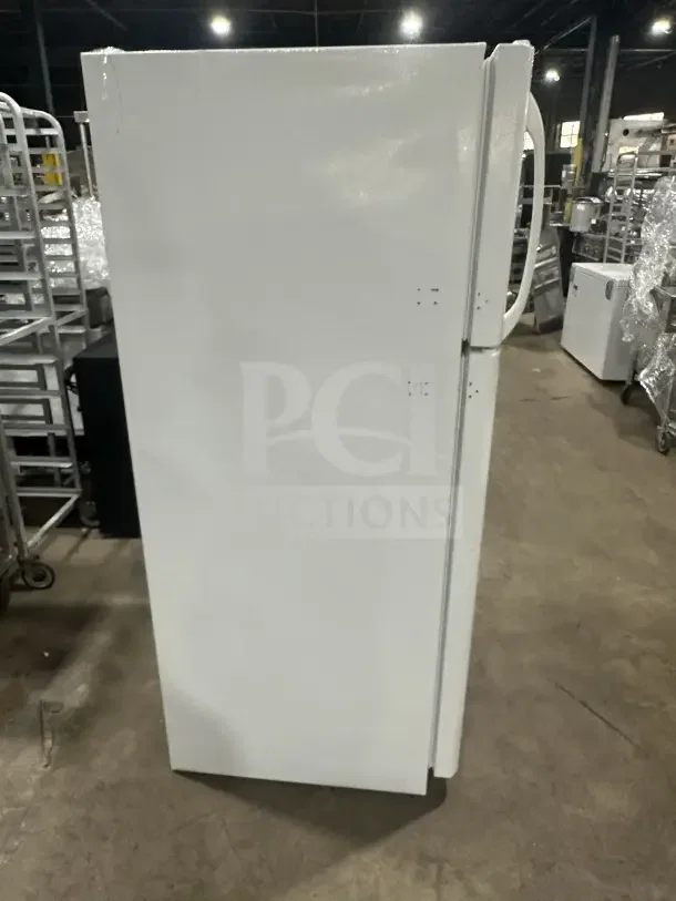 Frigidaire white top-freezer refrigerator, Model FRT18G2NW9, with poly-coated wired rack, good condition.