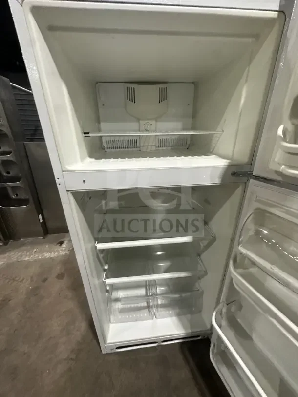 Frigidaire white top-freezer refrigerator, model FRT18G2NW9, features poly coated wired racks, excellent condition.