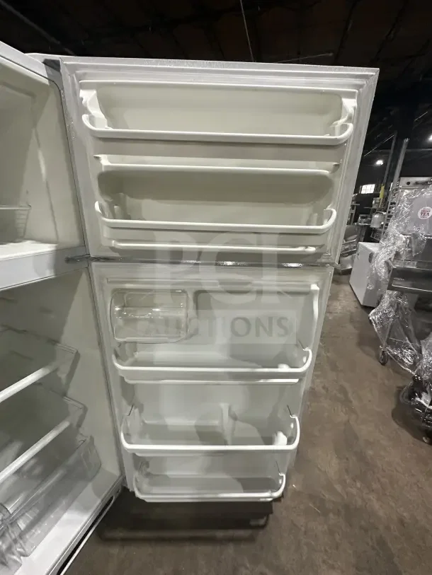 Frigidaire FRT18G2NW9 white top-freezer refrigerator with poly-coated wired rack, excellent condition, spacious door storage.