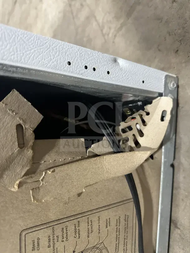 Frigidaire FRT18G2NW9 top-freezer refrigerator detail, showcasing poly coated wired rack and wiring.
