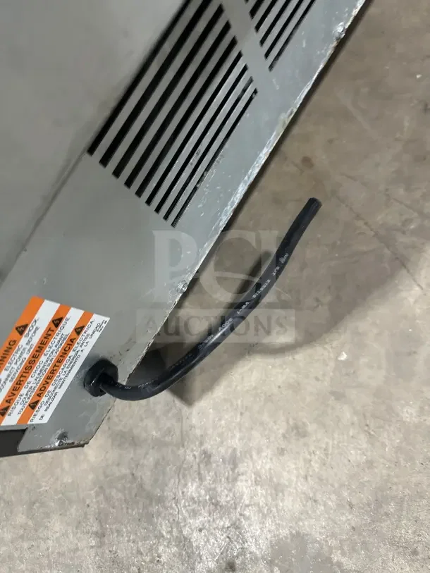 Manitowoc UDF0310W-161B undercounter ice machine, stainless steel, on legs, visible power cable and safety label.