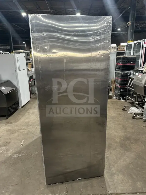 Leader LS54SC stainless steel reach-in refrigerator with rear access sliding glass doors, poly-coated rack, good condition.